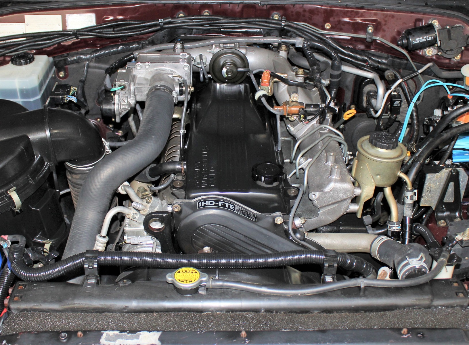 A Landcruiser engine bay fitted with a 1HD-FTE Engine